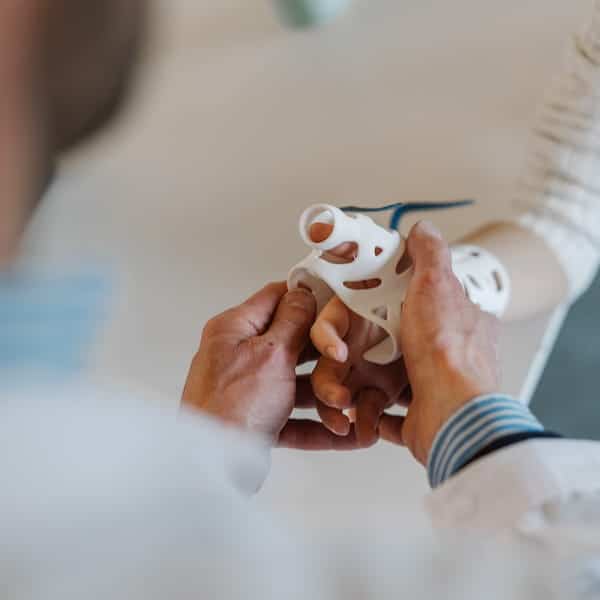 doctor applying a wrist brace to a patient