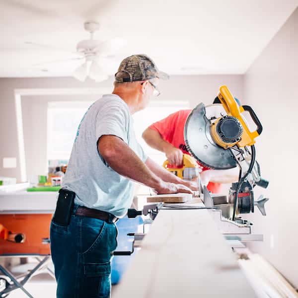 workmen using a circular saw